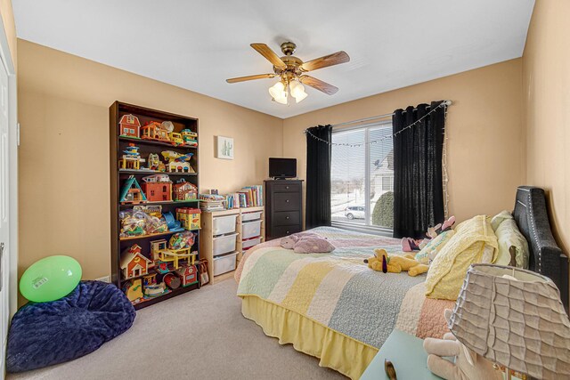 carpeted bedroom featuring ceiling fan and a closet