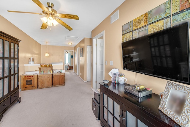 living room with light carpet and ceiling fan