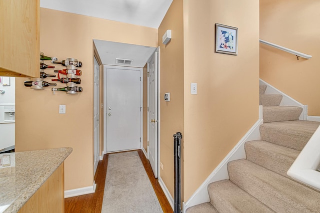 corridor with light hardwood / wood-style flooring