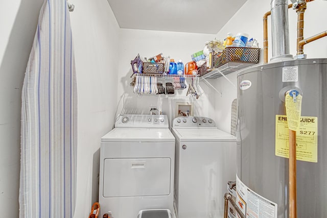 laundry room with washing machine and clothes dryer and gas water heater