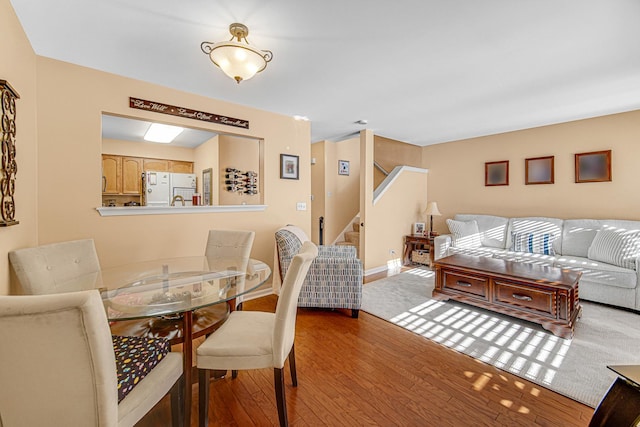 dining space with wood-type flooring