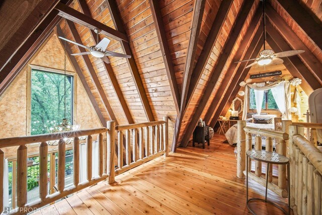 additional living space featuring lofted ceiling with beams, wood ceiling, and light wood-type flooring