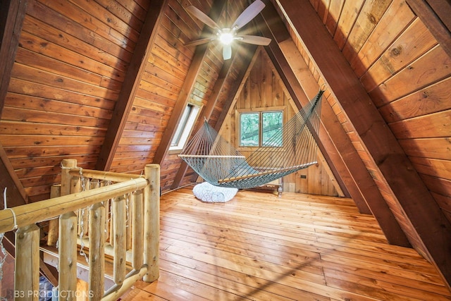 bonus room featuring vaulted ceiling with beams, wood walls, wooden ceiling, and light wood-style floors