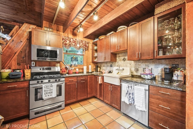 kitchen featuring appliances with stainless steel finishes, sink, beamed ceiling, light tile patterned floors, and wood ceiling