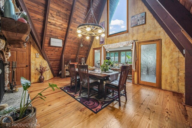 dining area with light wood-type flooring, beamed ceiling, wooden ceiling, and a chandelier