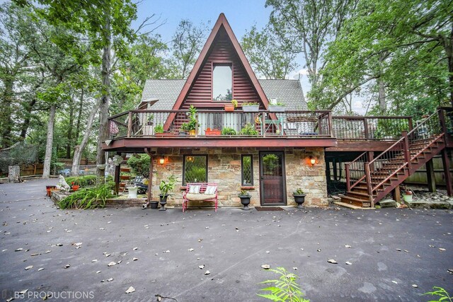 rear view of house with a wooden deck