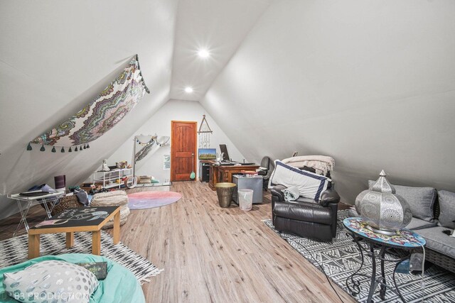 additional living space featuring lofted ceiling and hardwood / wood-style floors