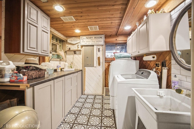 clothes washing area with wooden ceiling, a sink, cabinet space, and electric panel