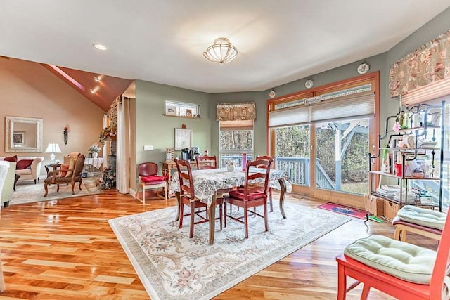 dining room featuring hardwood / wood-style floors and lofted ceiling