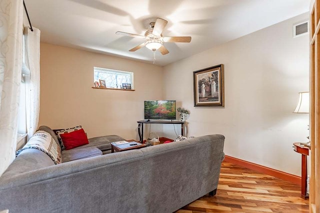 living room featuring ceiling fan and light wood-type flooring