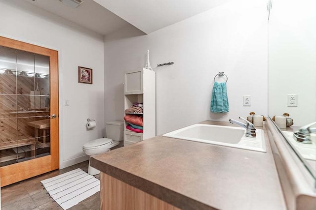 bathroom with tile patterned floors, vanity, and toilet