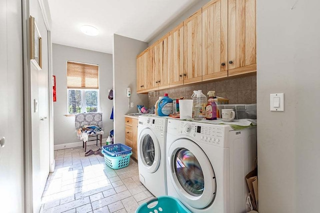 laundry room with cabinets, light tile patterned floors, and independent washer and dryer