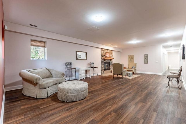 living room with a fireplace and dark hardwood / wood-style floors