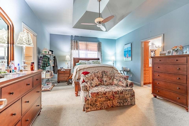 bedroom with ensuite bathroom, ceiling fan, and light colored carpet