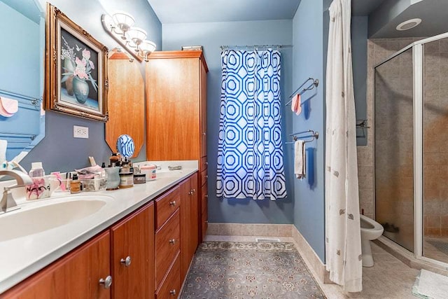 bathroom featuring a shower with shower door, vanity, tile patterned floors, and toilet