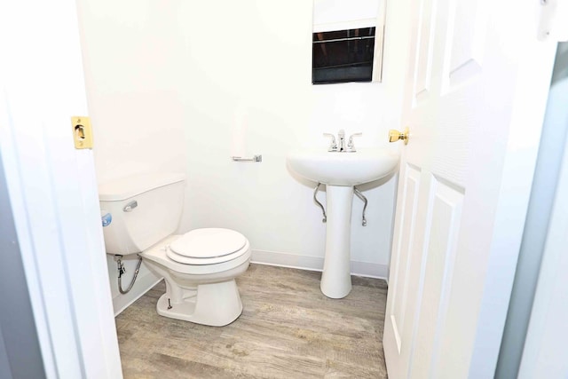 bathroom featuring toilet and hardwood / wood-style floors