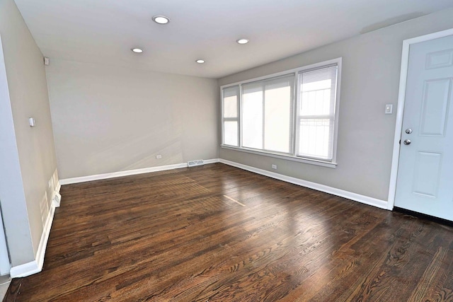 unfurnished room featuring dark hardwood / wood-style flooring