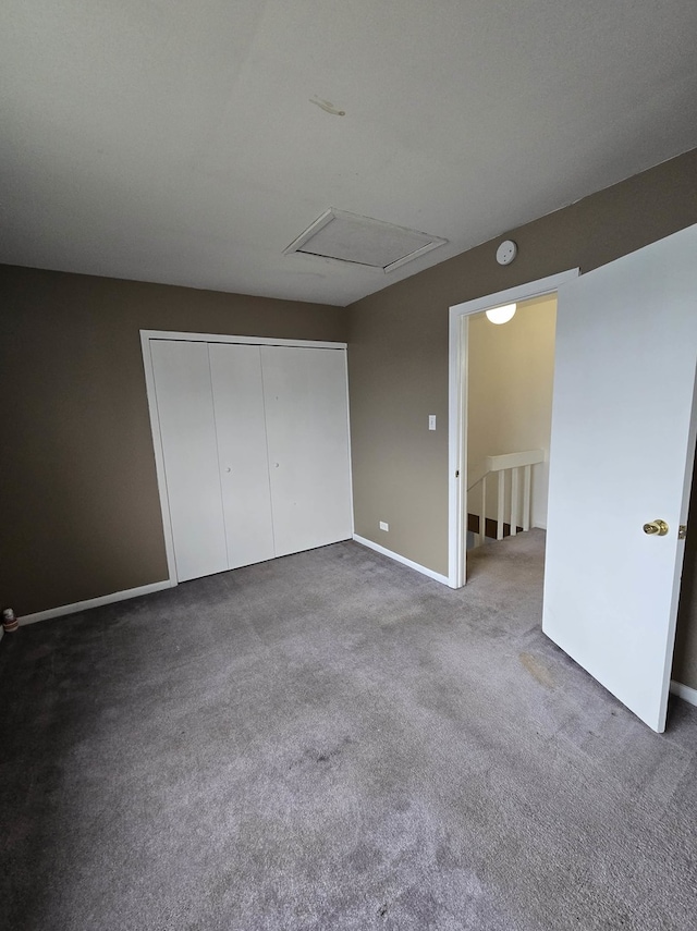 unfurnished bedroom with a closet and carpet flooring