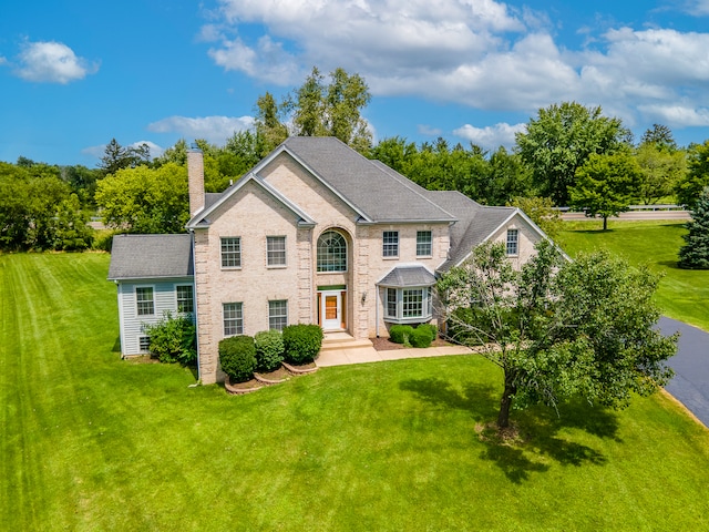 colonial home with a front lawn