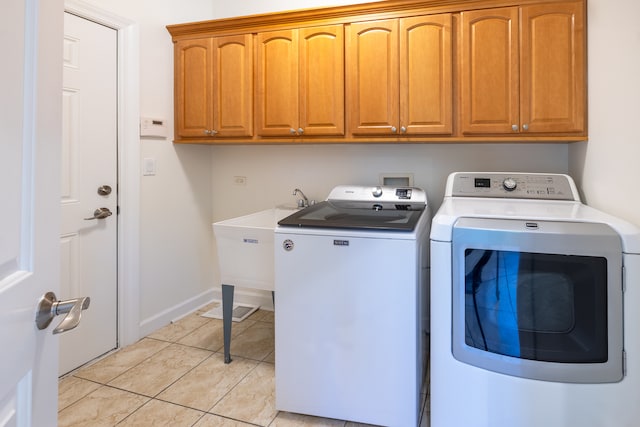 laundry area with cabinets and washing machine and dryer