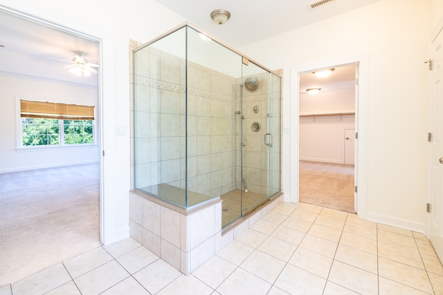 bathroom featuring ceiling fan, walk in shower, and tile patterned floors