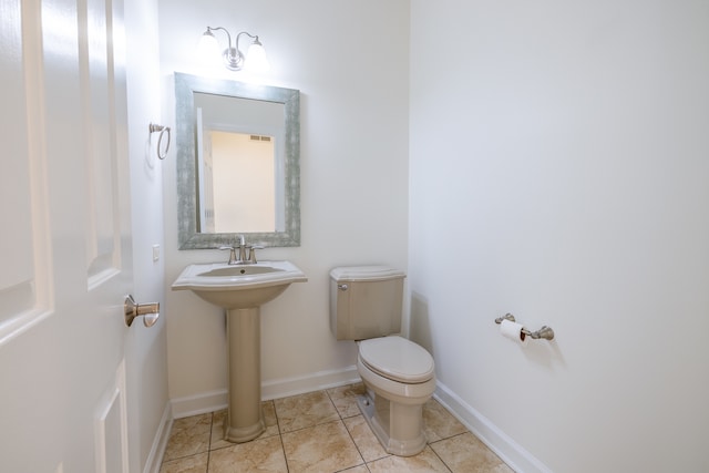 bathroom with toilet and tile patterned flooring