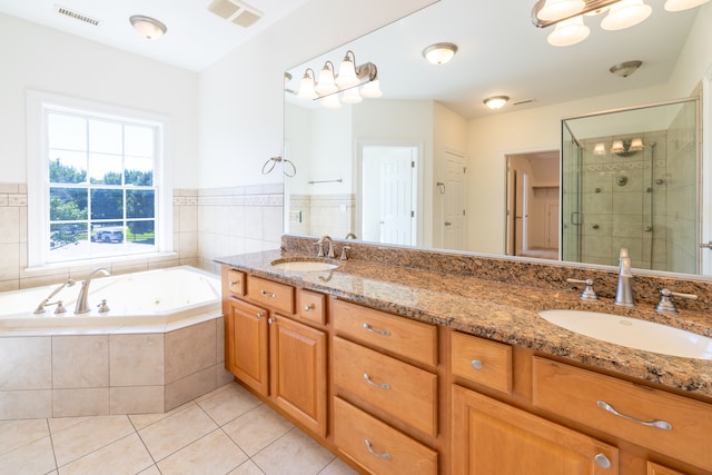 bathroom with vanity, tile patterned floors, and plus walk in shower