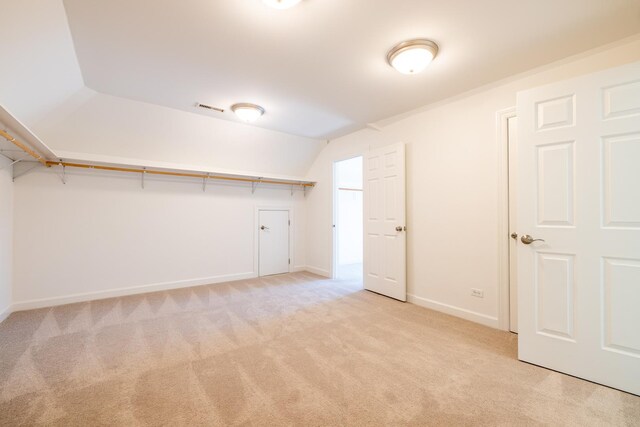 interior space with lofted ceiling, visible vents, and carpet flooring