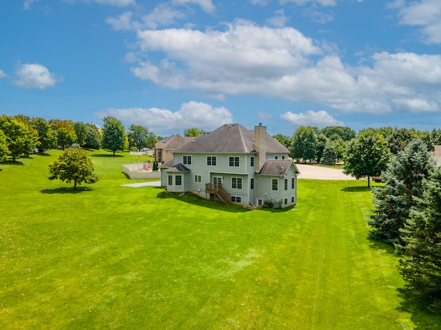 back of property featuring a yard