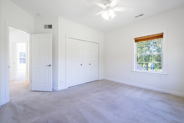 unfurnished bedroom featuring a closet, ceiling fan, and carpet floors