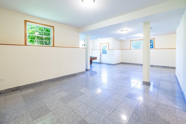 unfurnished room featuring granite finish floor and baseboards