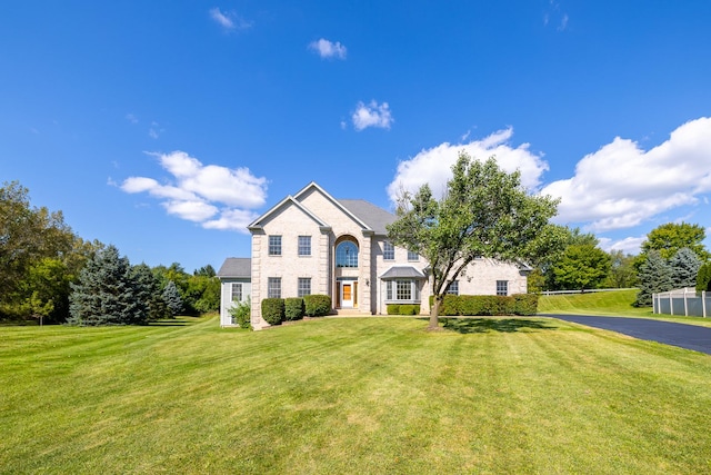 french country inspired facade with a front lawn