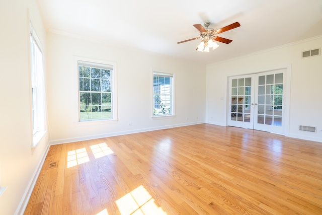 spare room with light hardwood / wood-style flooring, ceiling fan, ornamental molding, and french doors