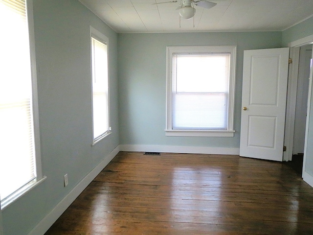 unfurnished room with ceiling fan and dark wood-type flooring