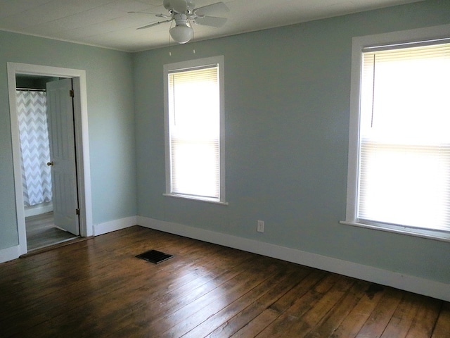 unfurnished room with wood-type flooring and a healthy amount of sunlight