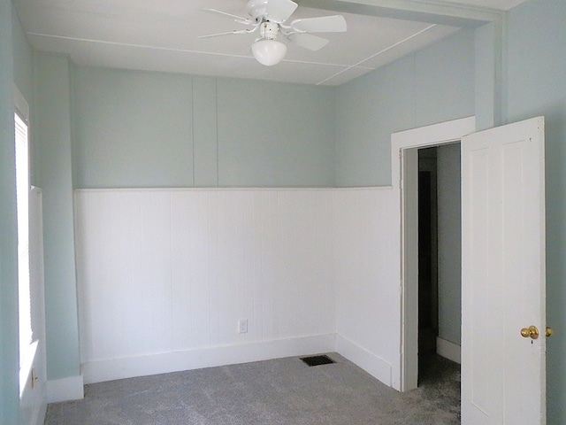 spare room featuring carpet and ceiling fan