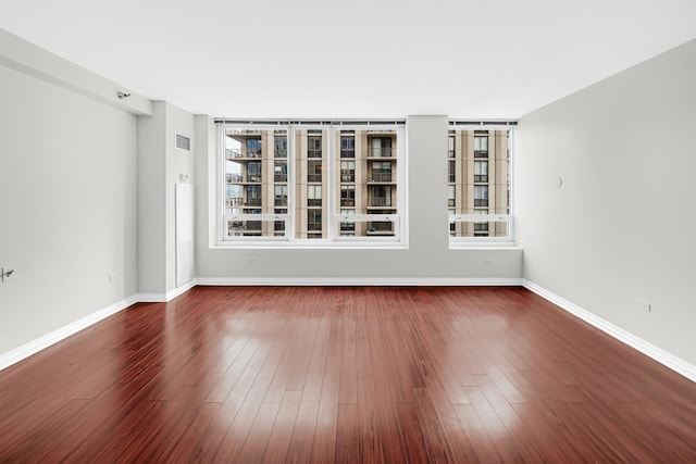 spare room featuring dark hardwood / wood-style flooring