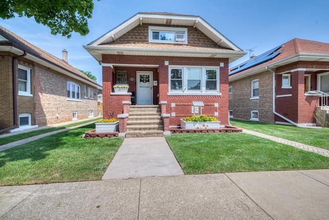 bungalow-style house with a front lawn and solar panels