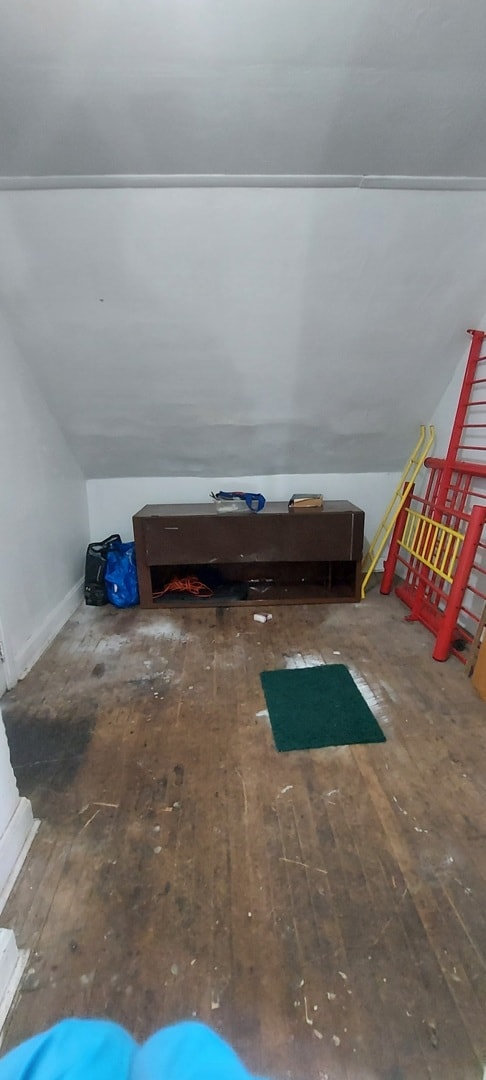 interior space featuring lofted ceiling and hardwood / wood-style flooring