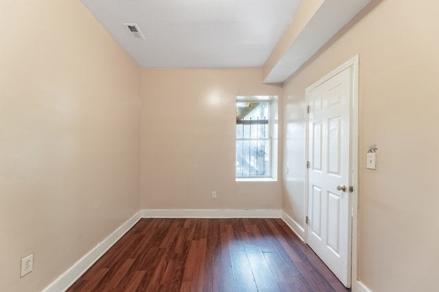 unfurnished room with dark hardwood / wood-style floors