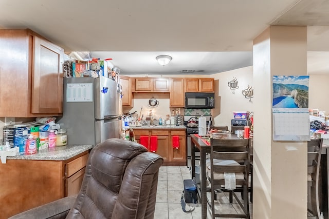 kitchen featuring appliances with stainless steel finishes and light tile patterned floors