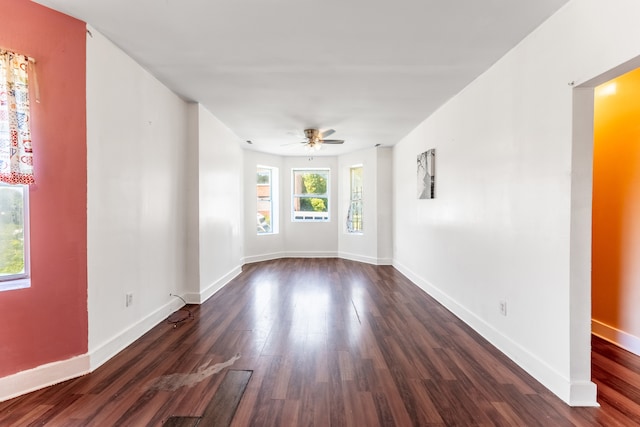 empty room with dark wood-type flooring and ceiling fan