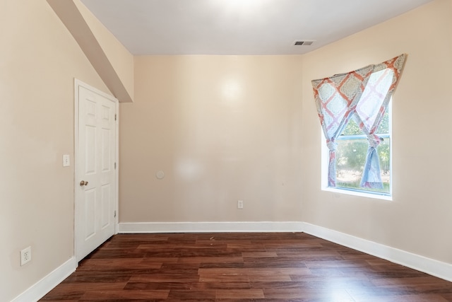 spare room with dark hardwood / wood-style flooring