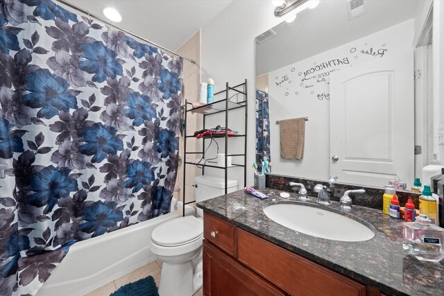 full bathroom featuring tile patterned floors, vanity, toilet, and shower / tub combo with curtain