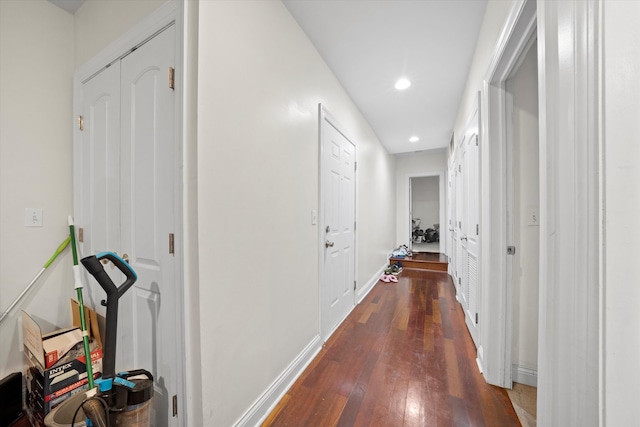 hallway with dark hardwood / wood-style flooring