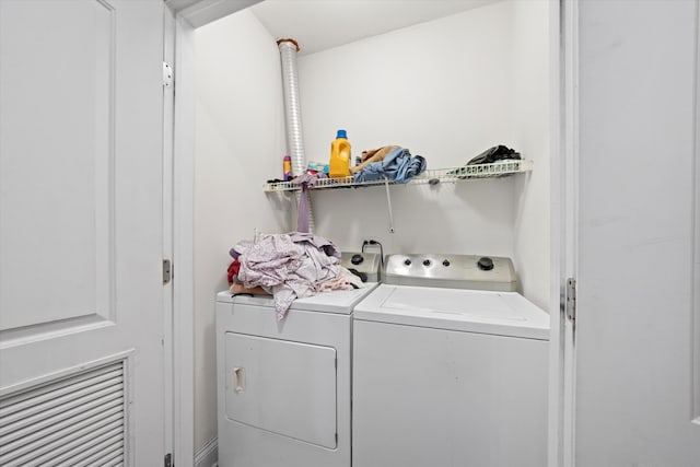 clothes washing area featuring independent washer and dryer