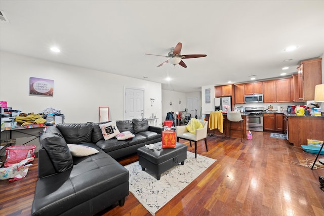 living room with wood-type flooring and ceiling fan