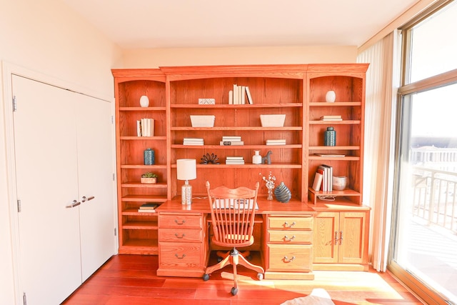 office area with built in study area and wood finished floors