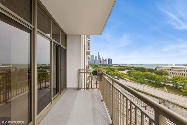 balcony with a view of city and a water view