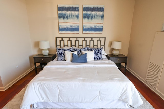 bedroom with baseboards and wood finished floors